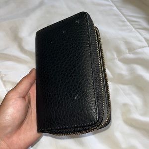 black wallet with gold zipper